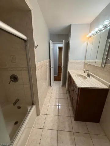 a bathroom with a sink a mirror and a bathtub