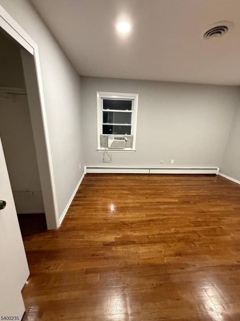 116 West Linden Avenue Linden, NJ 07036 - Photo 7 of 9 a view of an empty room with wooden floor and a window