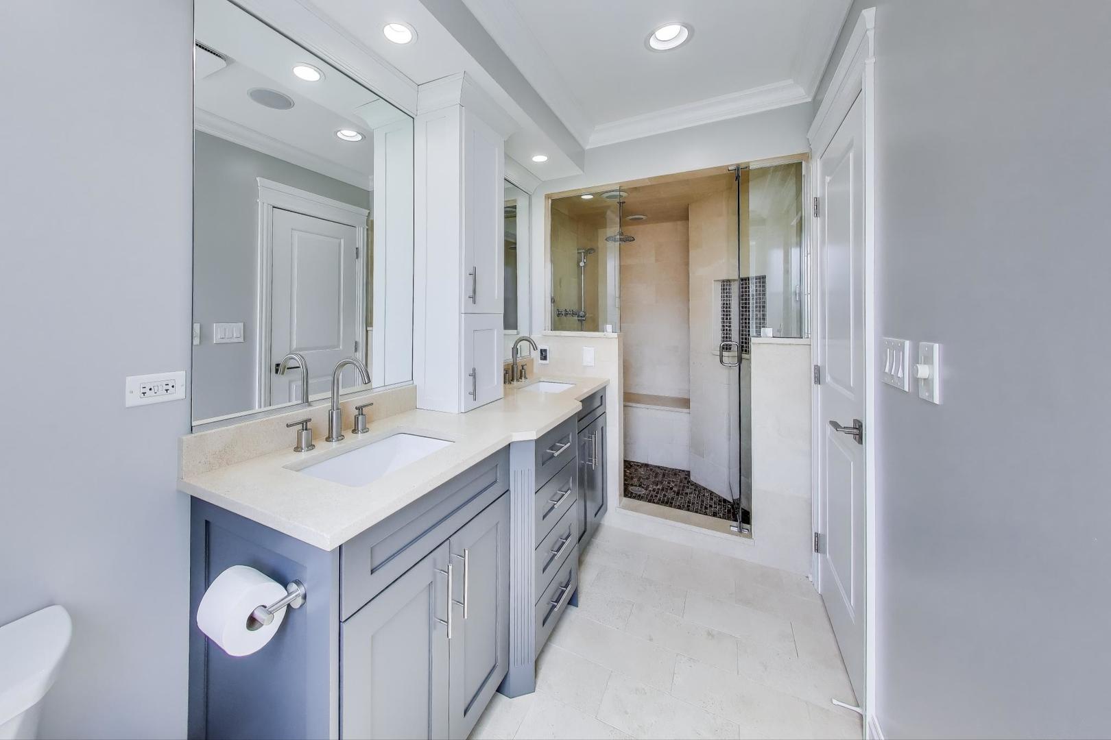 735 West Brompton Avenue, Unit 2E Chicago, IL 60657 - Photo 17 of 25 a spacious bathroom with a double vanity sink a mirror and a bathtub