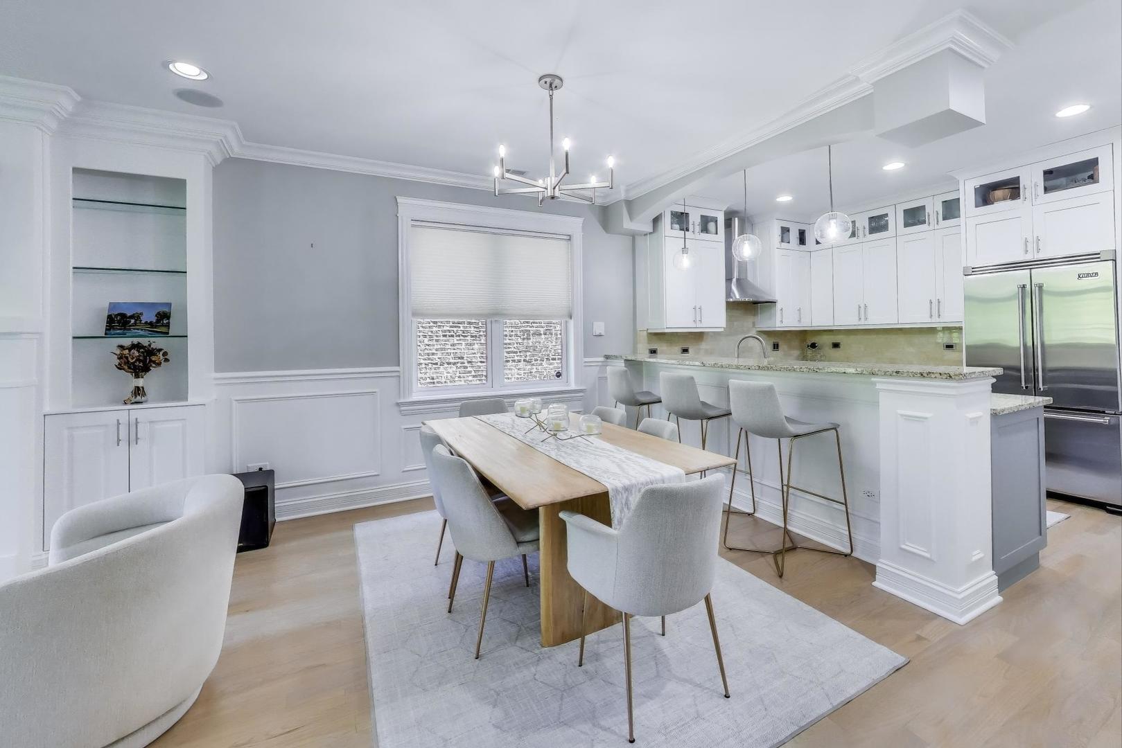 735 West Brompton Avenue, Unit 2E Chicago, IL 60657 - Photo 4 of 25 a kitchen with kitchen island granite countertop a sink a center island stainless steel appliances and cabinets