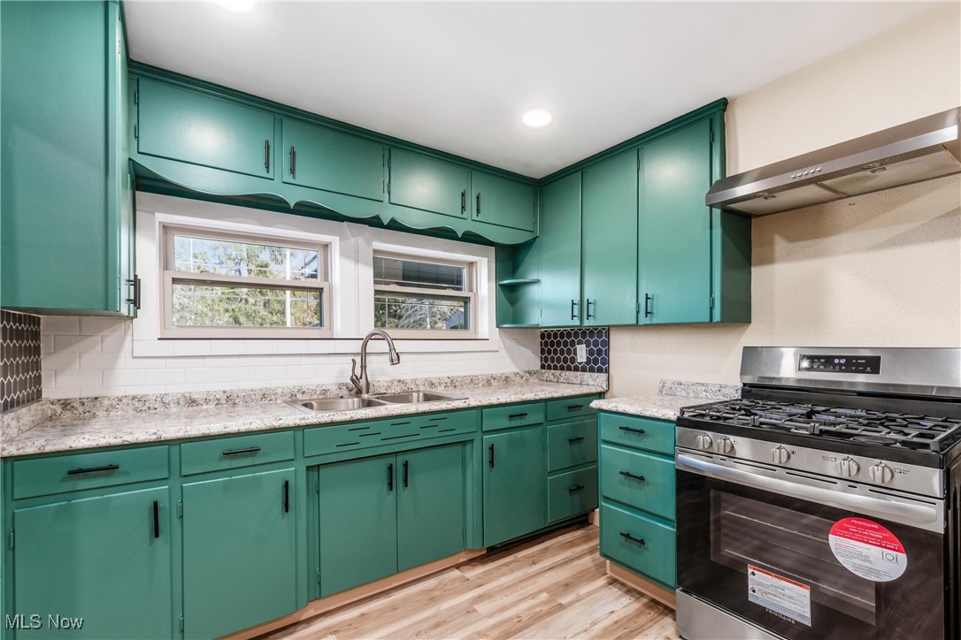 724 Garden Road Zanesville, OH 43701 - Photo 9 of 22 Kitchen featuring green cabinets, gas stove, light wood-type flooring, ventilation hood, and recessed lighting