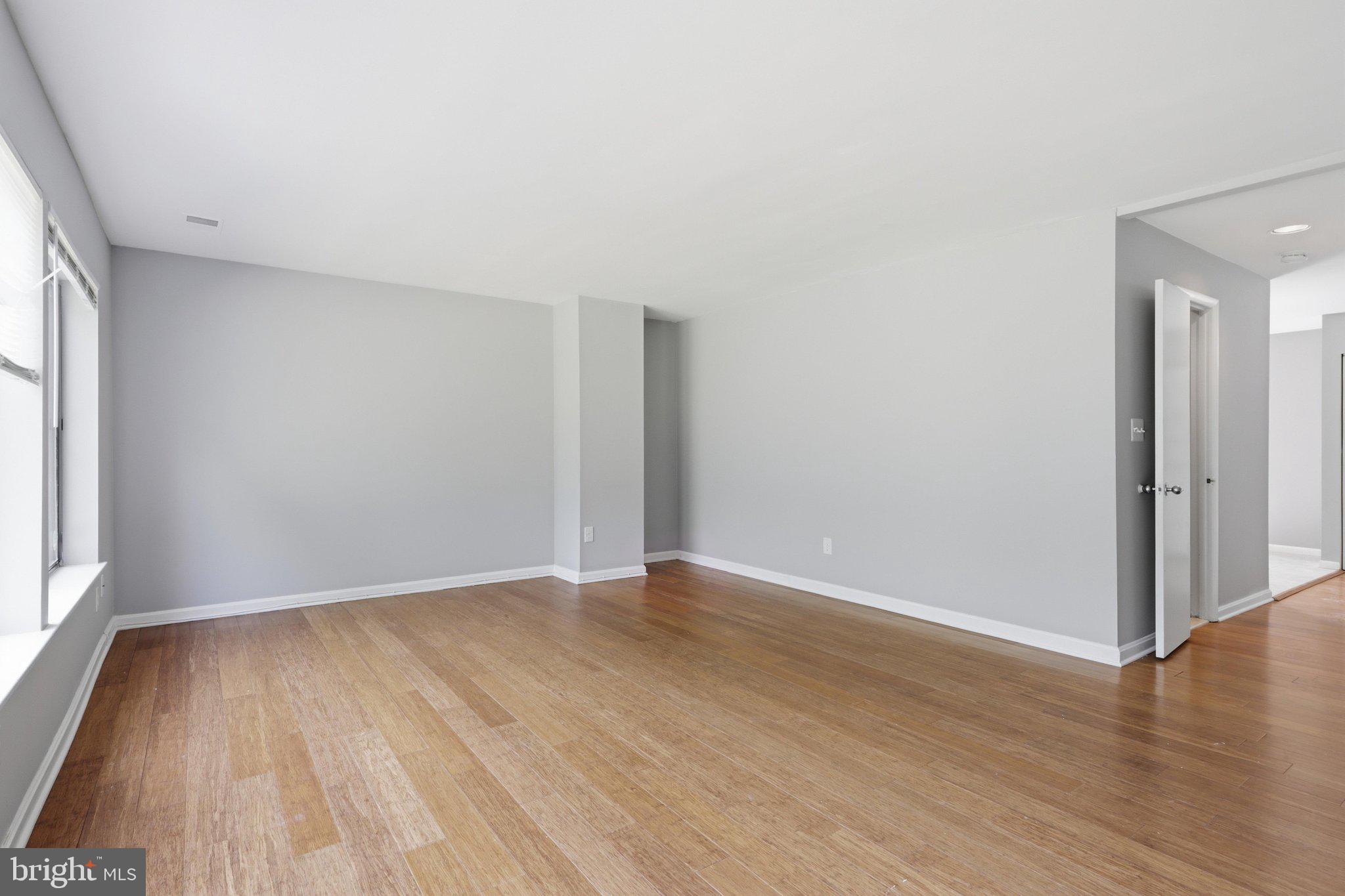 5538 Vantage Point Road Columbia, MD 21044 - Photo 12 of 50 an empty room with wooden floor and windows