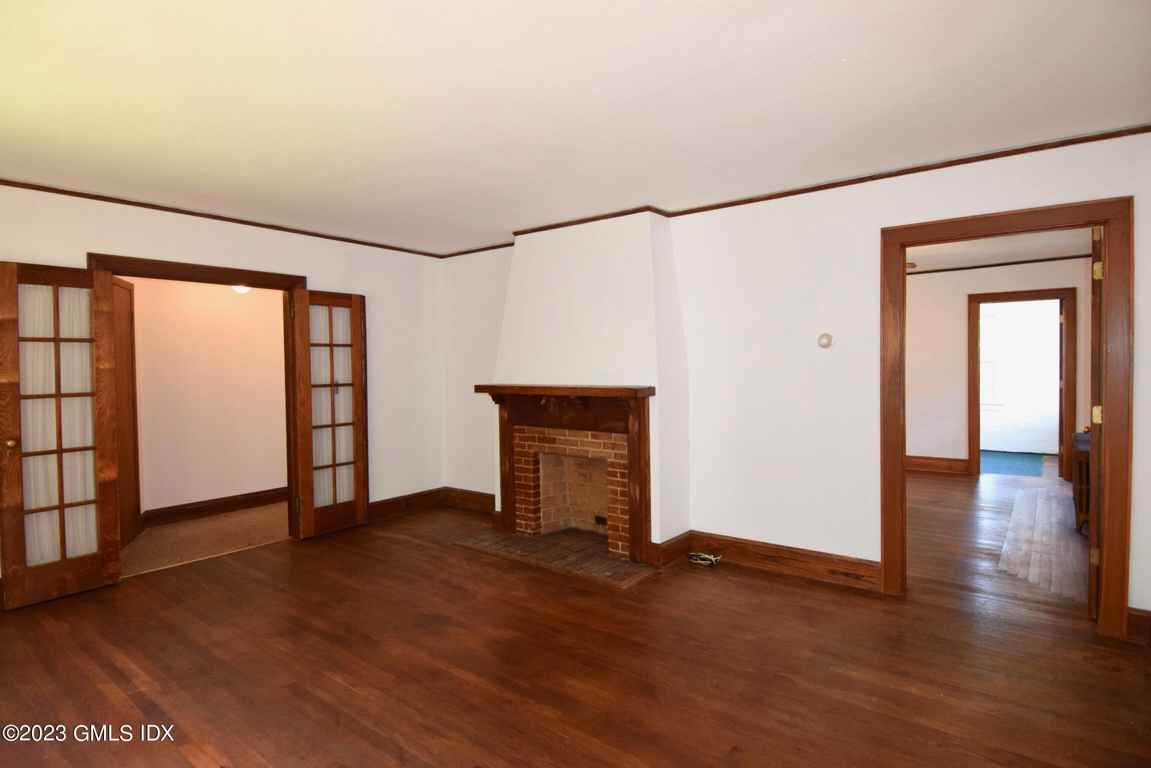 6 Pemberwick Road Greenwich, CT 06831 - Photo 11 of 32 an empty room with wooden floor and windows