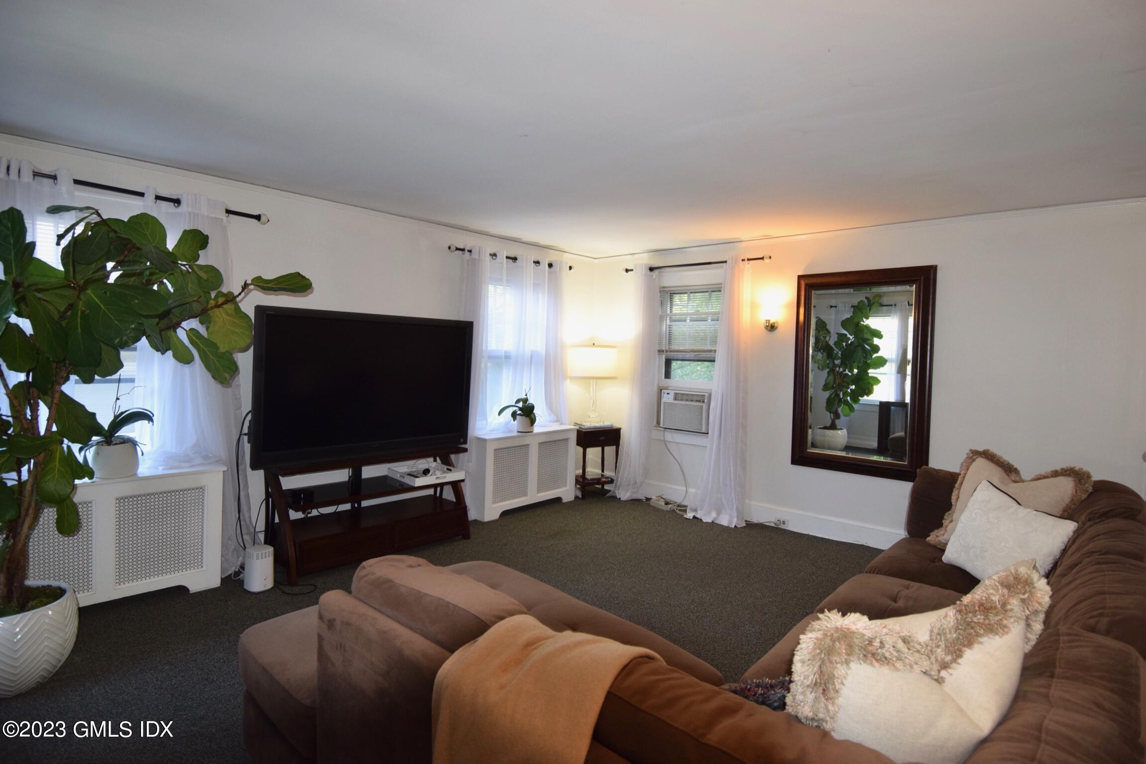6 Pemberwick Road Greenwich, CT 06831 - Photo 22 of 32 a living room with furniture and a flat screen tv