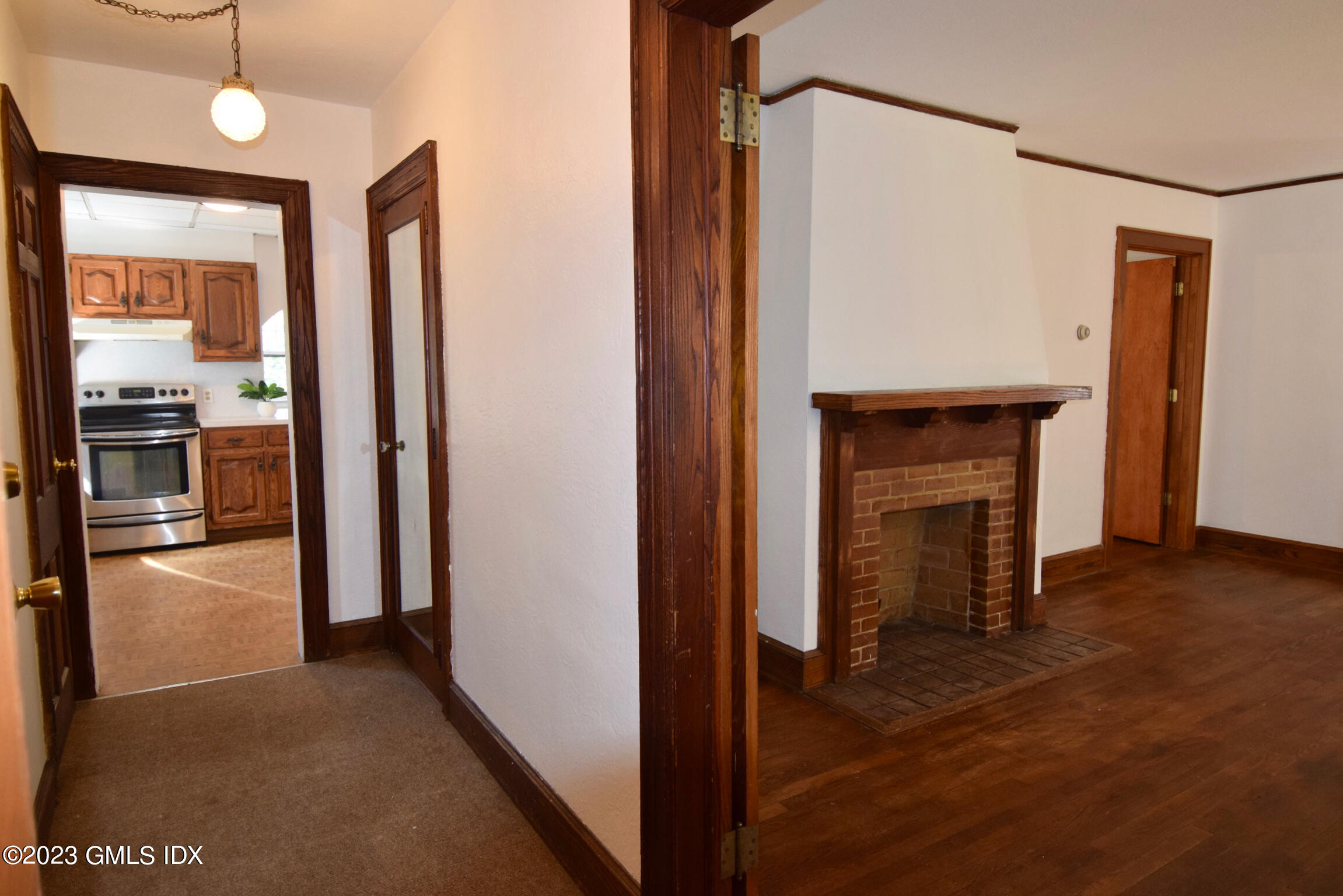 6 Pemberwick Road Greenwich, CT 06831 - Photo 4 of 32 a view of a hallway with wooden floor and a fireplace