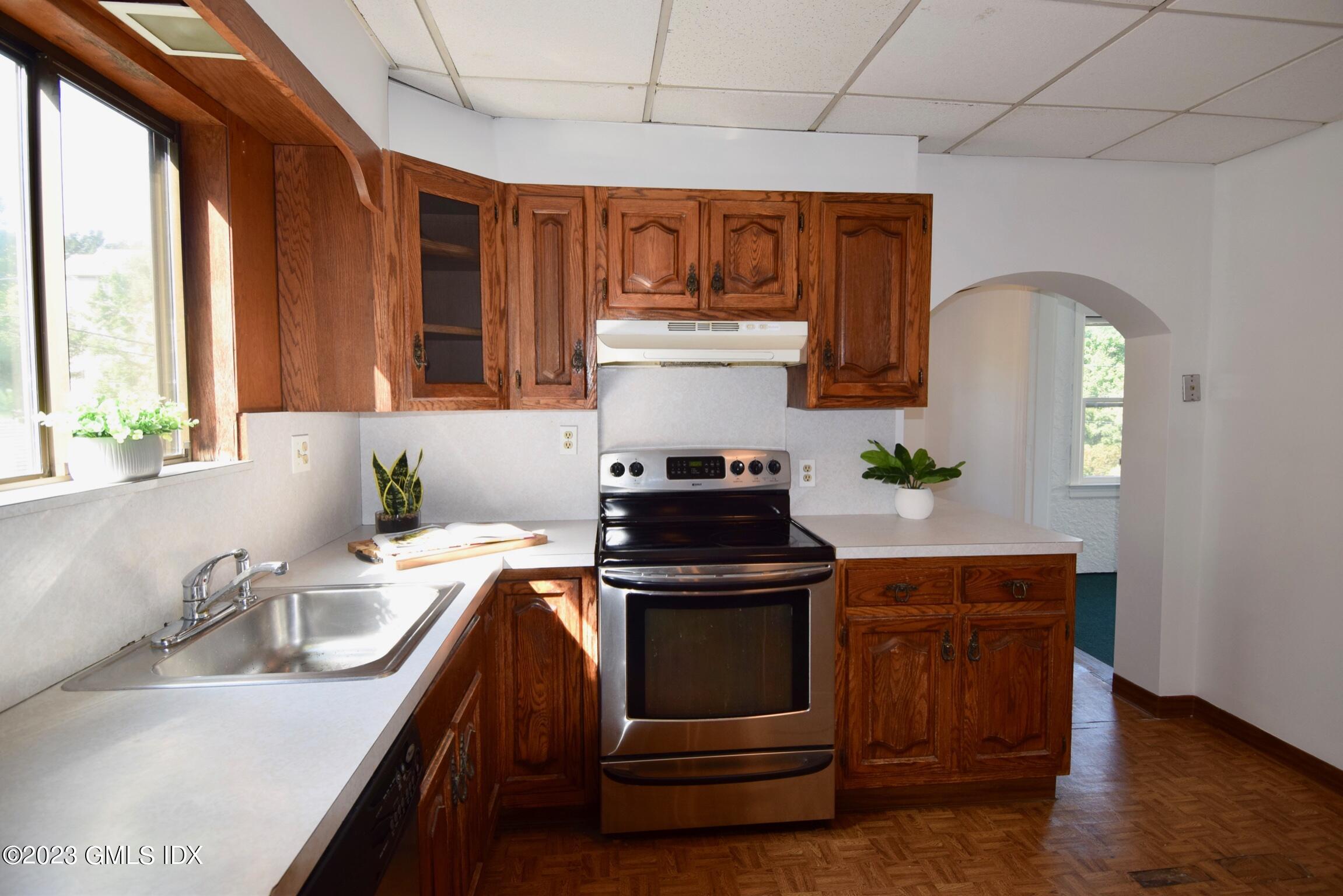 6 Pemberwick Road Greenwich, CT 06831 - Photo 5 of 32 a kitchen with stainless steel appliances granite countertop a sink a stove and a wooden floors