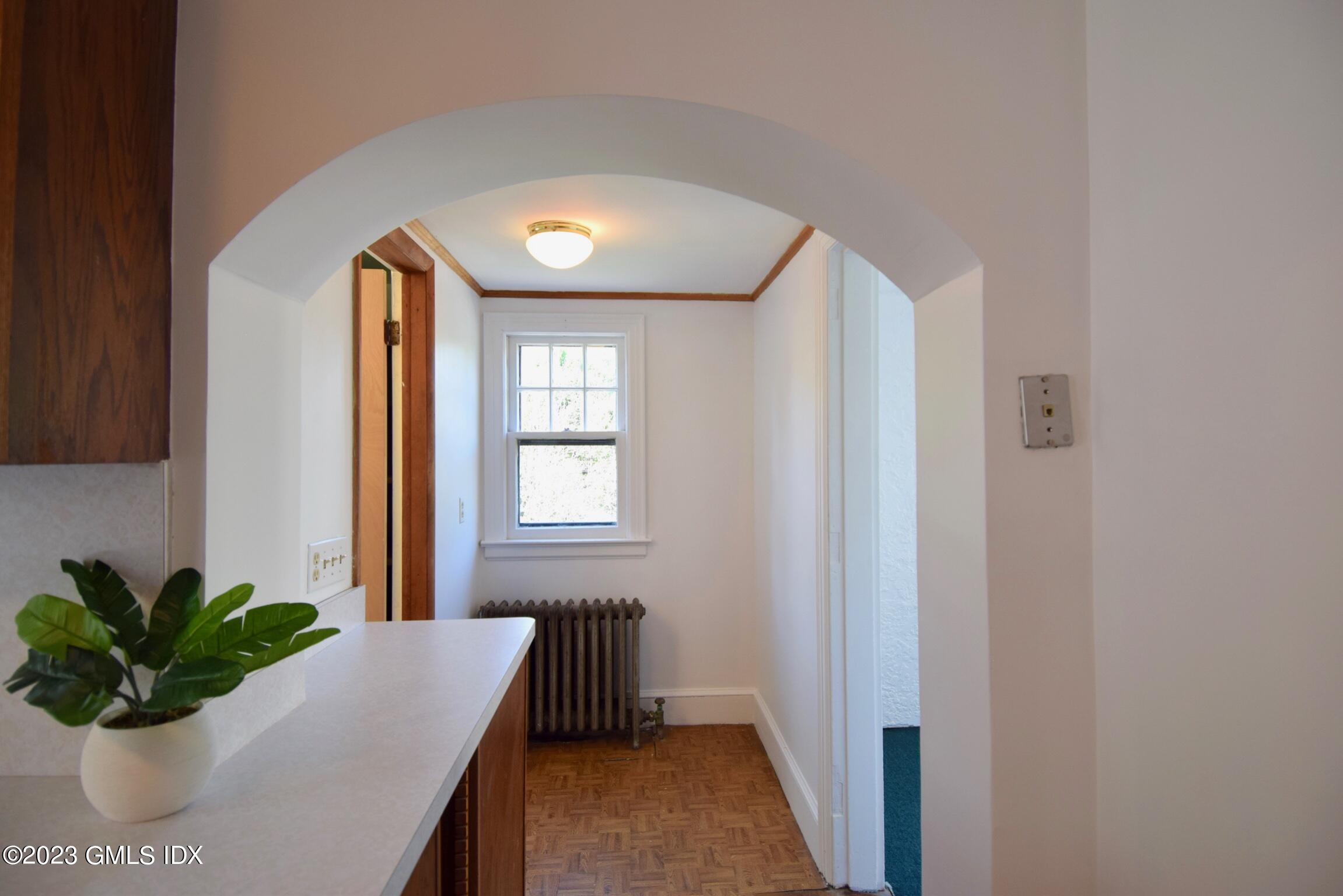 6 Pemberwick Road Greenwich, CT 06831 - Photo 7 of 32 a room with window and a potted plant