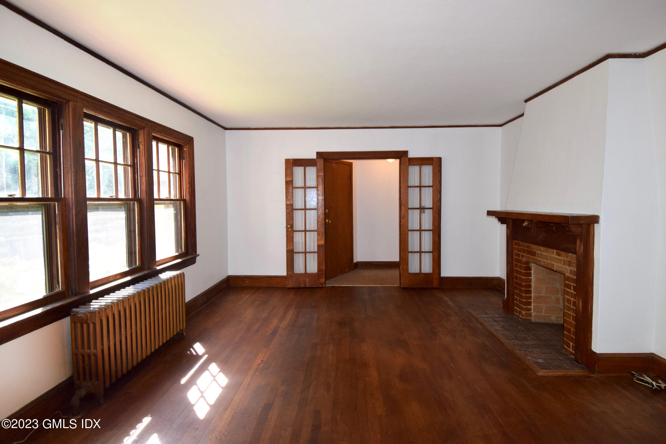 6 Pemberwick Road Greenwich, CT 06831 - Photo 10 of 32 an empty room with wooden floor and windows
