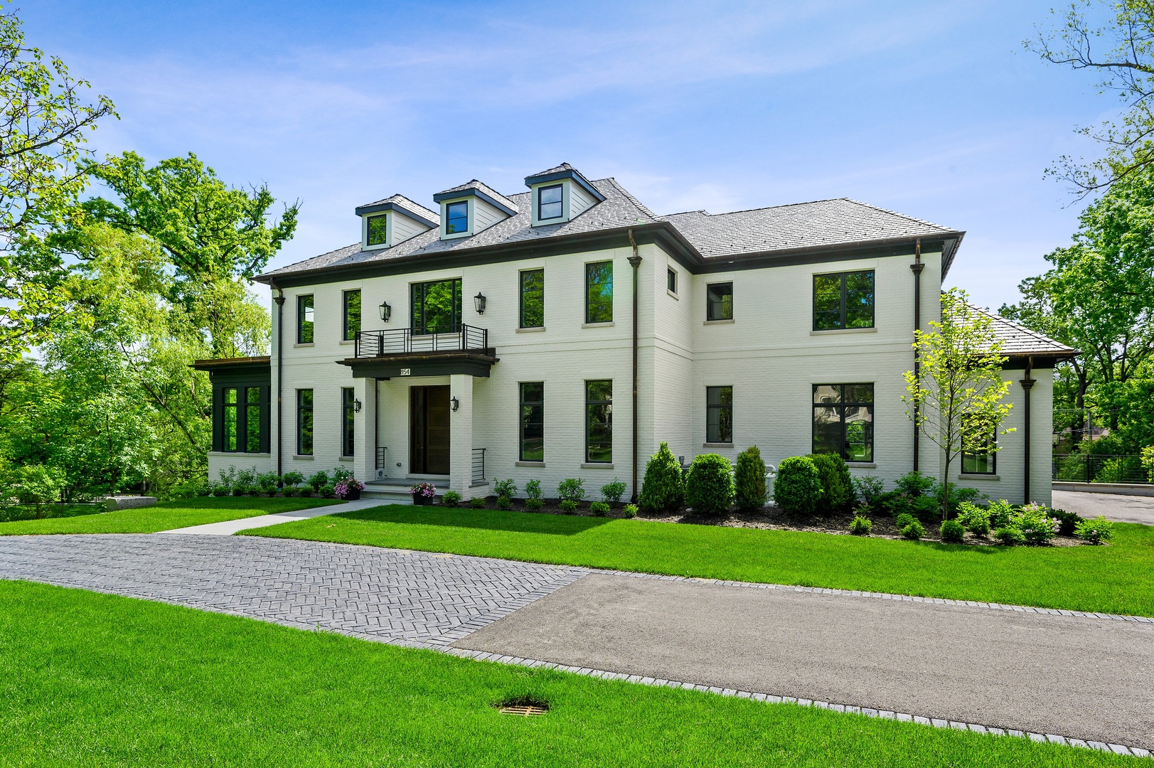 854 Bluff Street Glencoe, IL 60022 - Photo 2 of 37 a front view of a house with a garden