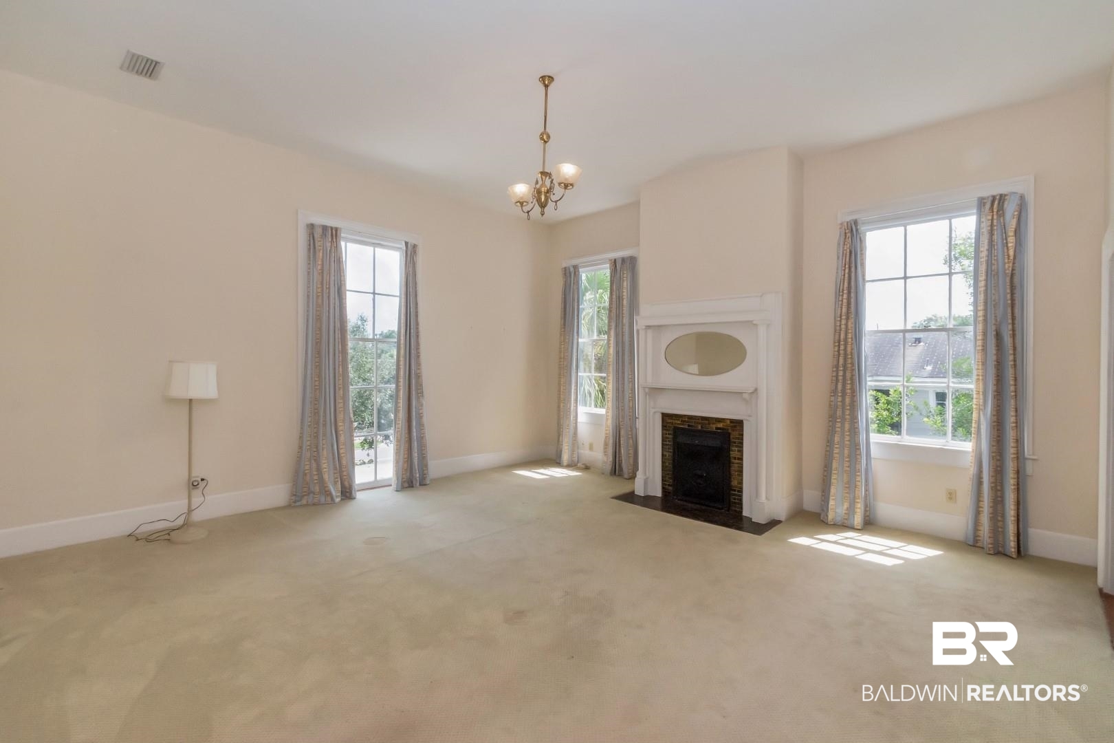 959 Dauphin Street Mobile, AL 36604 - Photo 19 of 43 Unfurnished living room featuring a healthy amount of sunlight and light colored carpet