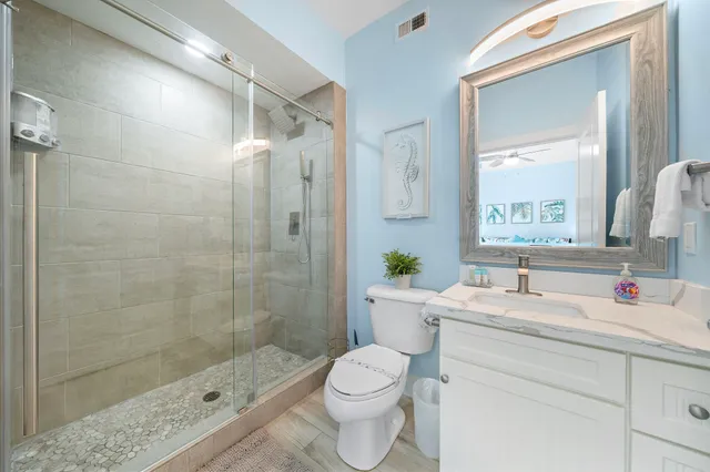 a bathroom with a sink toilet and shower