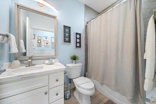 a bathroom with a toilet a sink and a mirror