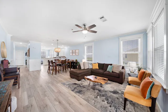a living room with furniture and wooden floor