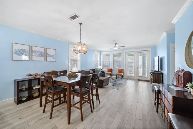 a view of a dining room with furniture wooden floor and chandelier
