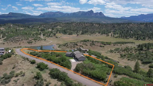 a view of a workspace with furniture and wooden floor