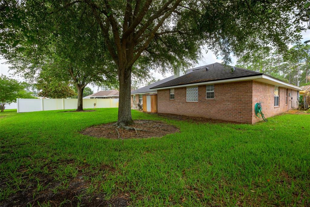 11 Riddle Drive Palm Coast, FL 32164 - Photo 24 of 33 a front view of house with a garden