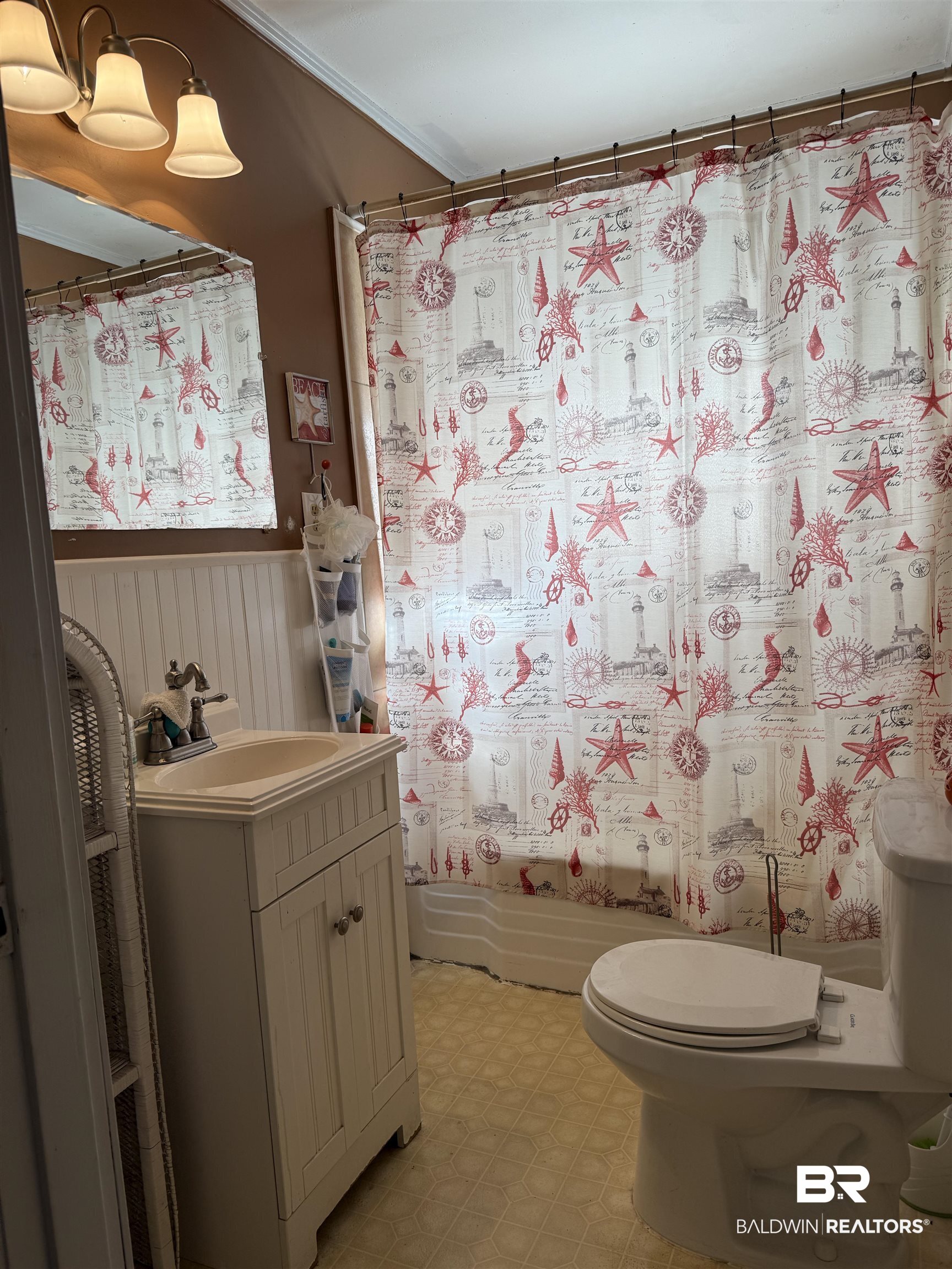 22173 1st Street Silverhill, AL 36576 - Photo 13 of 16 Bathroom featuring vanity, shower / bath combination with curtain, light floors, and ornamental molding