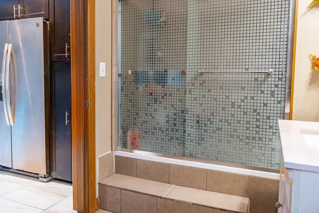 a bathroom with a bathtub and shower