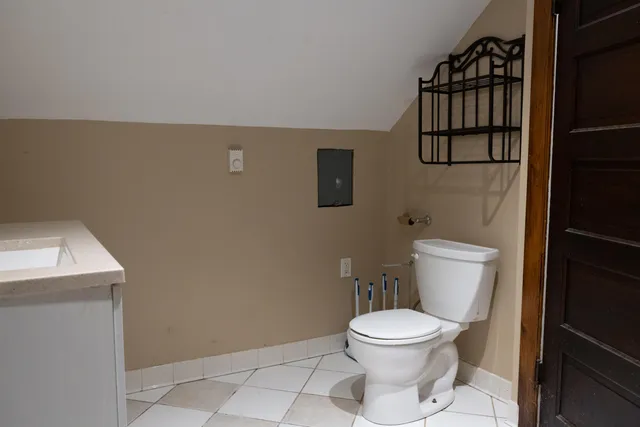 a white toilet sitting next to a bathroom sink