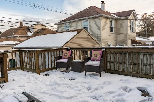 a view of a house with a wooden roof deck