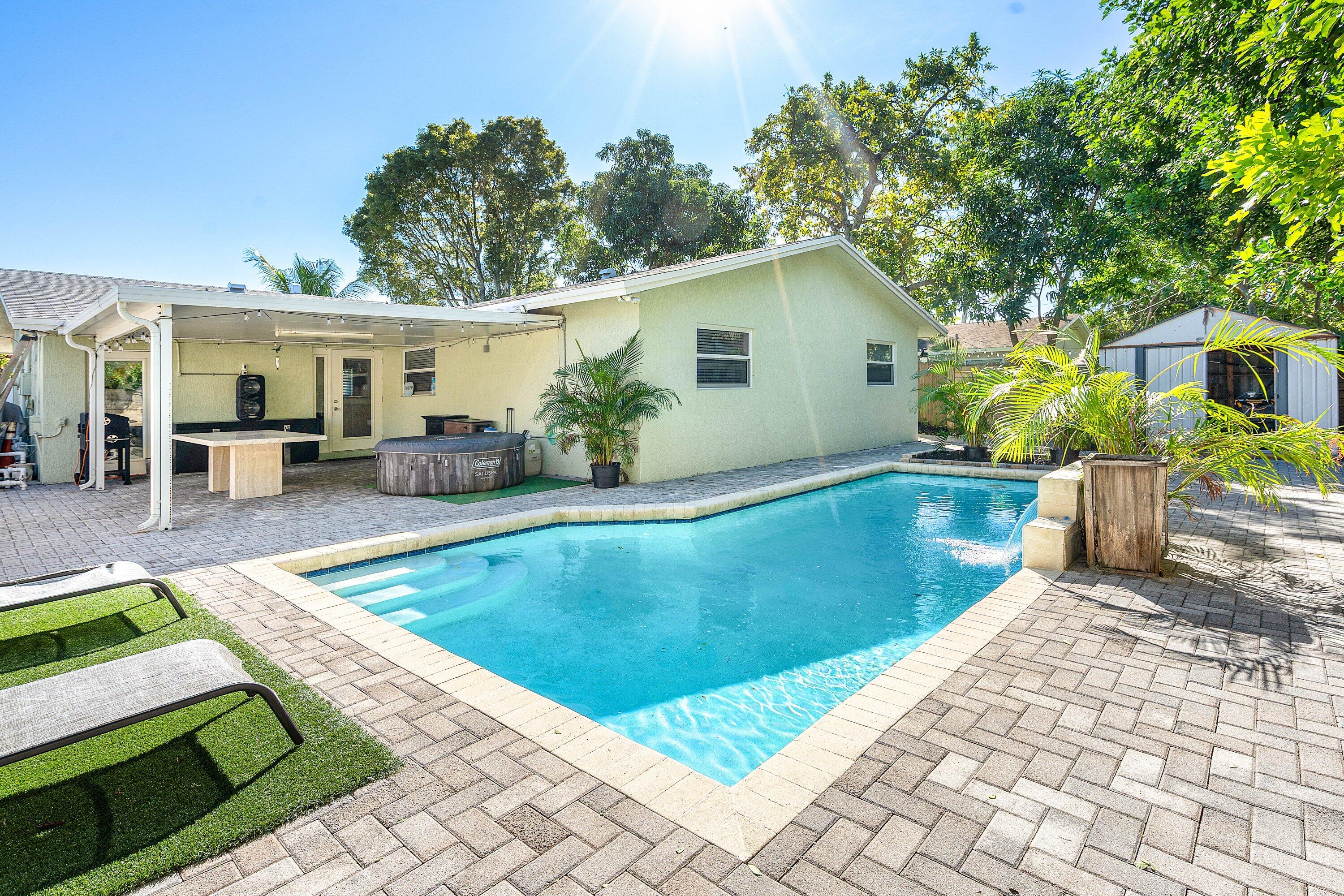 22207 Southwest 65th Terrace Boca Raton, FL 33428 - Photo 21 of 27 a view of a house with pool fire pit a patio and swimming pool
