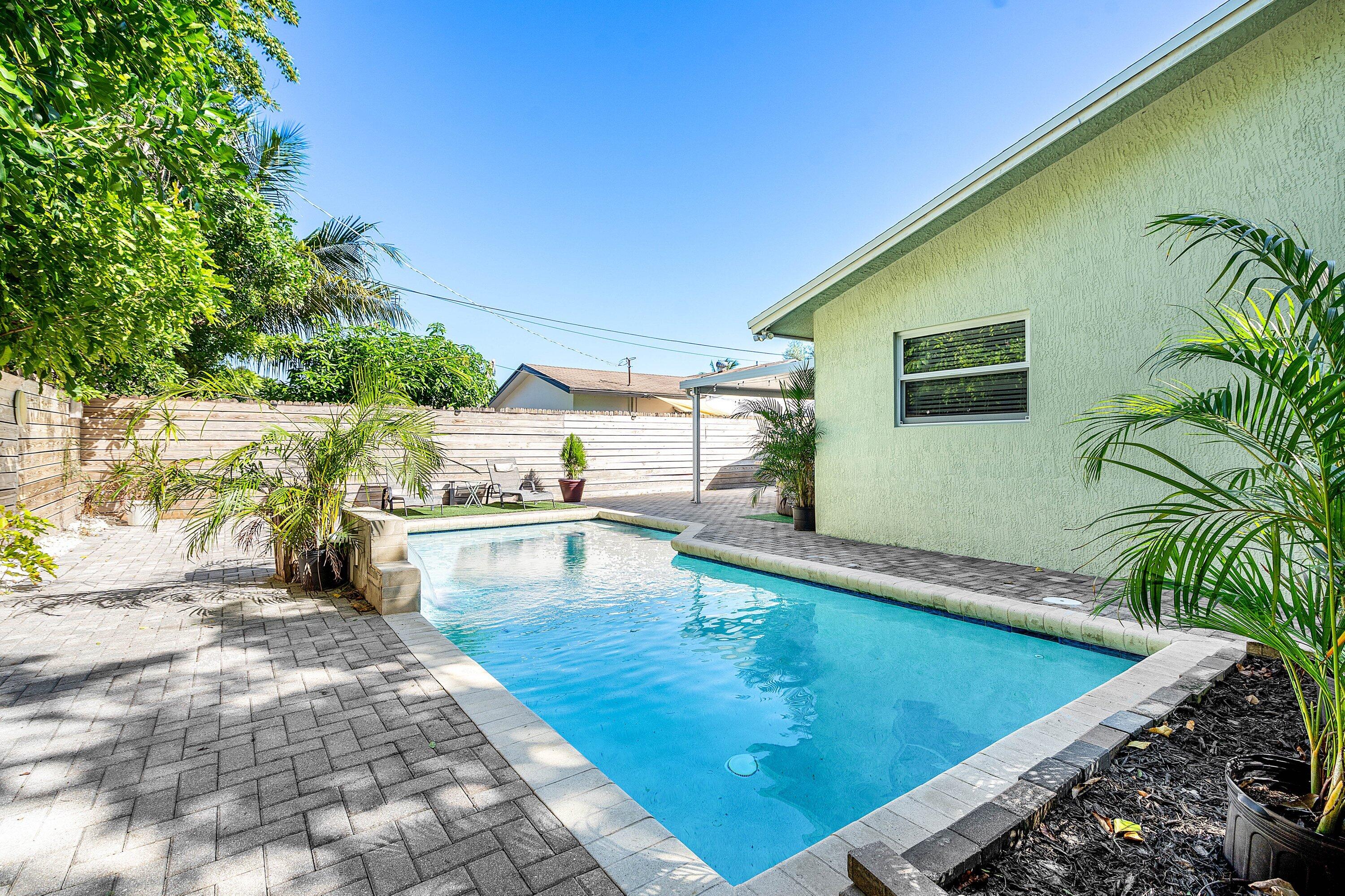 22207 Southwest 65th Terrace Boca Raton, FL 33428 - Photo 24 of 27 a view of a swimming pool with an outdoor seating