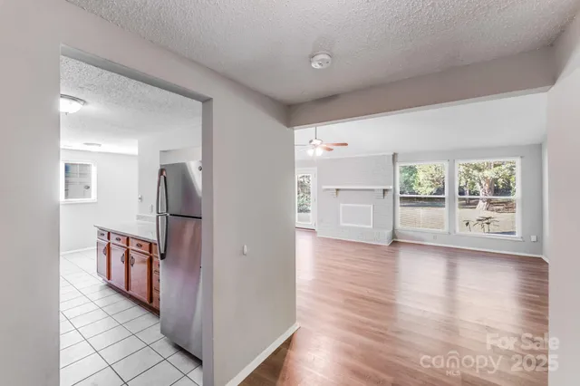 a view of a livingroom with wooden floor and a ceiling fan