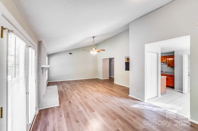 a view of empty room with wooden floor and cabinet