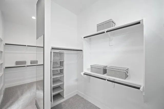 a view of walk in closet with empty racks