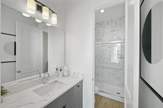 a bathroom with a bathtub sink vanity and mirror