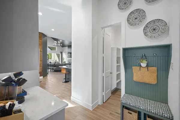 a view of a hallway to a livingroom with furniture