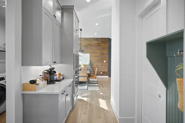 a kitchen with stainless steel appliances a sink stove and cabinets