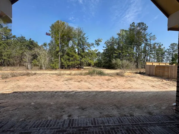 a view of dirt yard with a barn