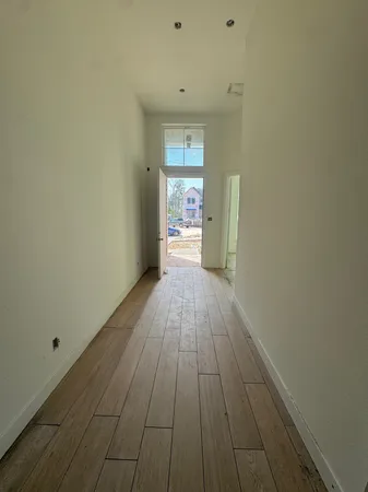 a view of a room with wooden floor