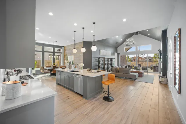 a large kitchen with a lot of counter space and a wooden floor