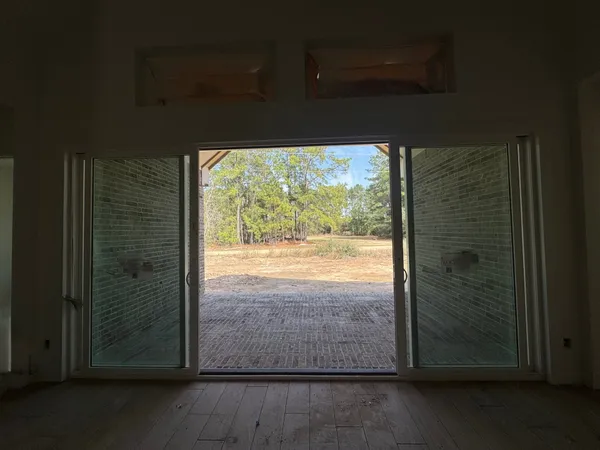 a view of a glass door with wooden floor