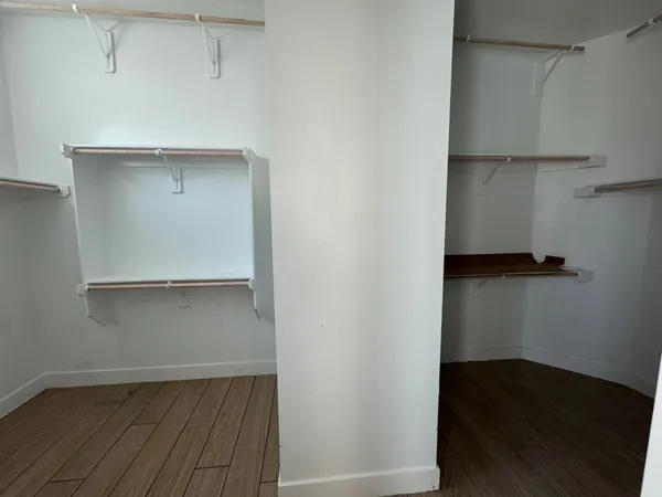 a view of walk in closet with clothes