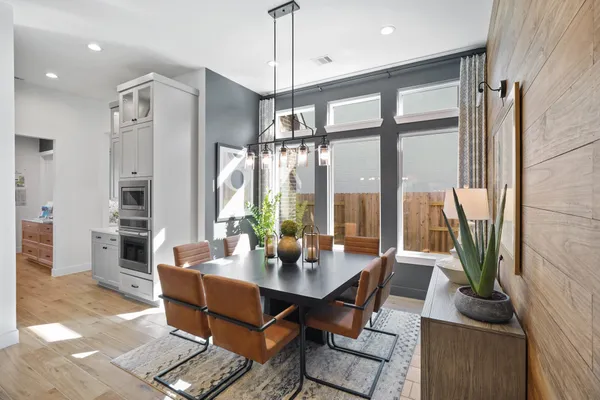 a living room with furniture and floor to ceiling windows