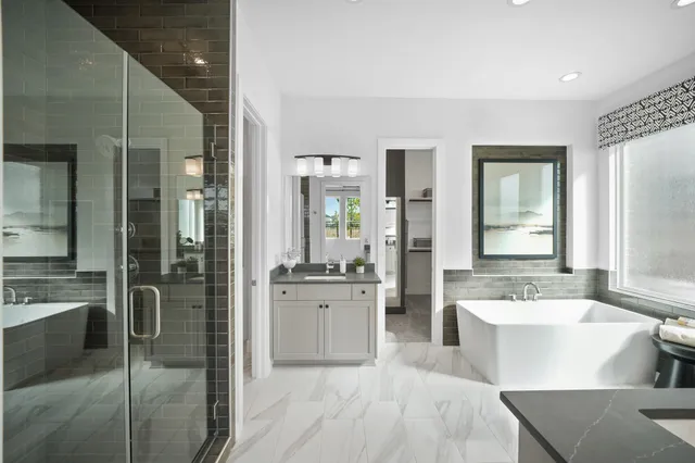 a spacious bathroom with a tub sink and mirror