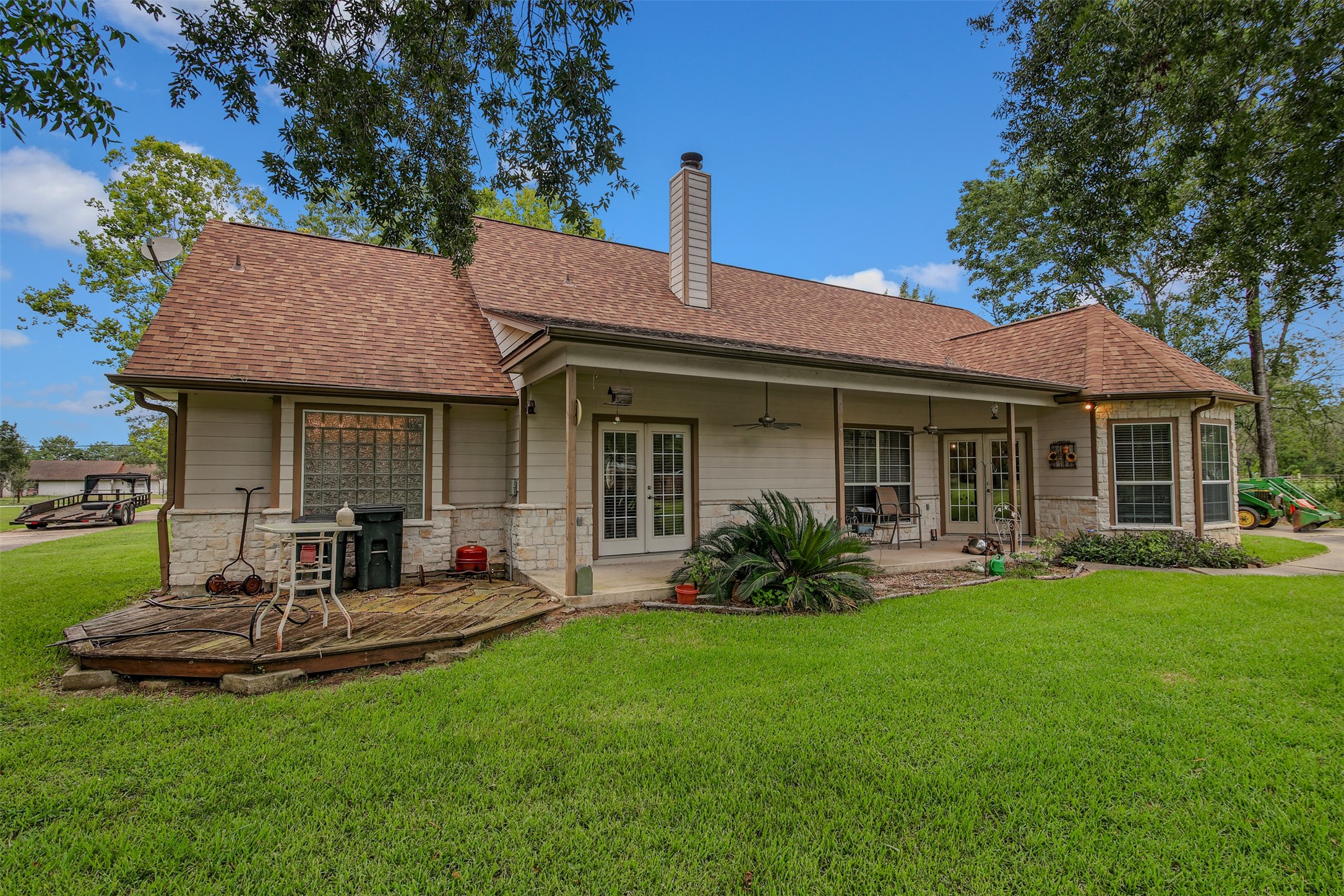 11692 Clark Lane Conroe, TX 77385 - Photo 21 of 35 The covered porch with ceilings fans and deck offer a peaceful setting and are perfect for those stressful days where you just need to wind down.