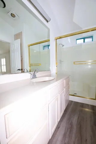 a bathroom with a double vanity sink and a mirror