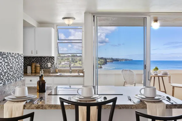 a kitchen with a stove a table and chairs