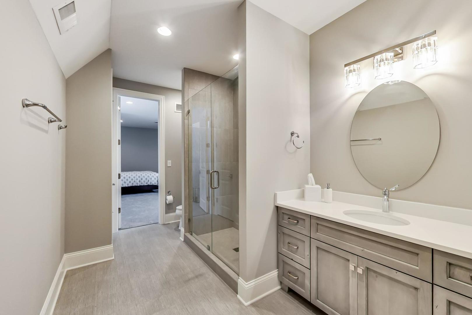 8310 Waterview Drive Burr Ridge, IL 60527 - Photo 18 of 35 a en suite bathroom with a double vanity sink and a mirror