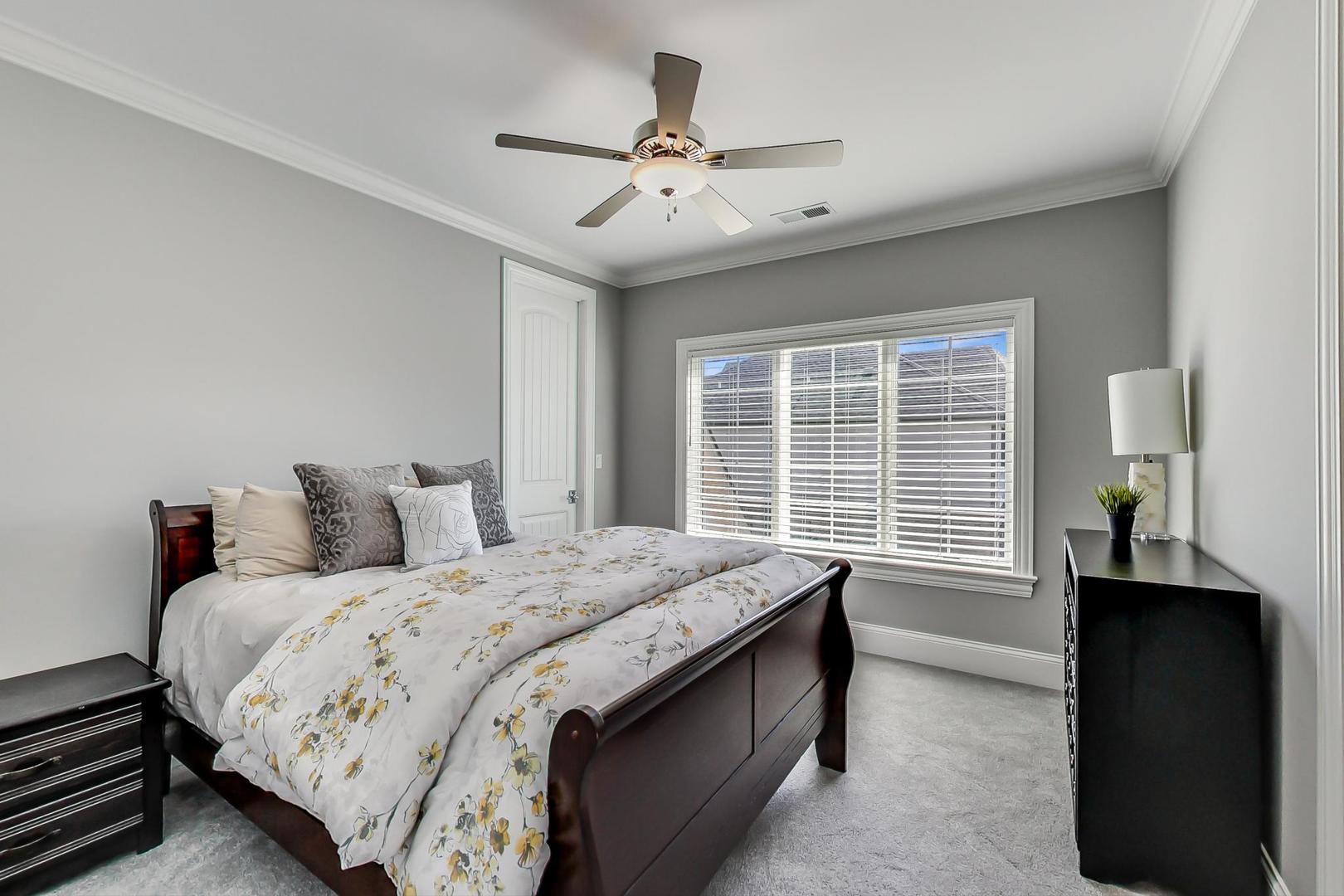 8310 Waterview Drive Burr Ridge, IL 60527 - Photo 19 of 35 a bedroom with a bed and a ceiling fan