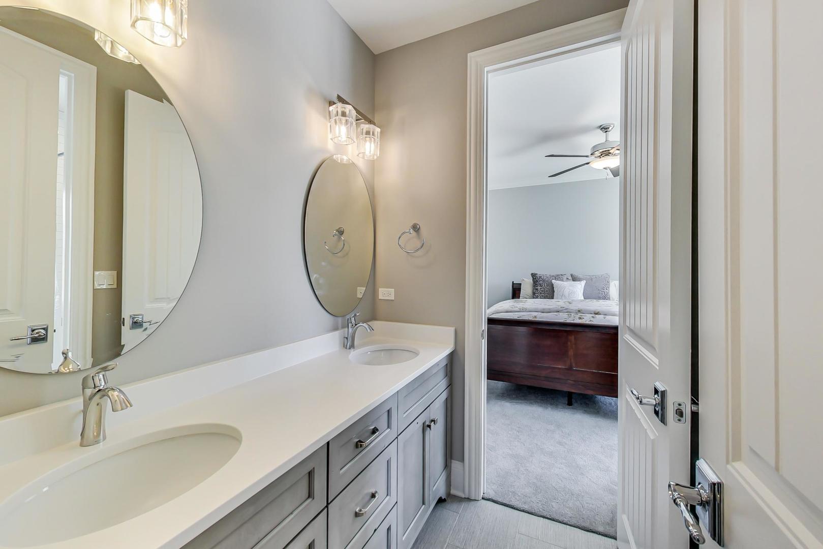 8310 Waterview Drive Burr Ridge, IL 60527 - Photo 20 of 35 a bathroom with 2 sink tub and a mirror
