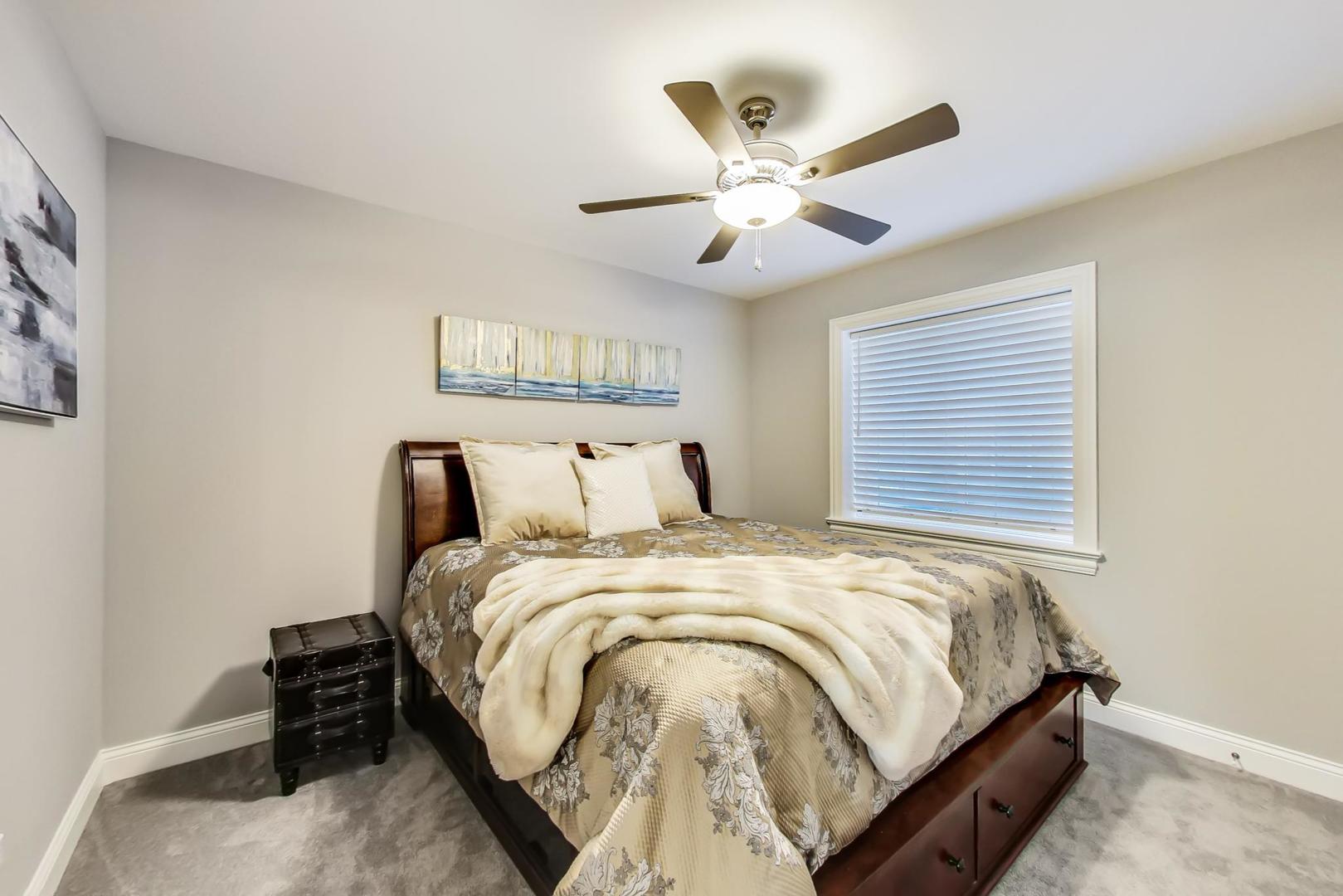 8310 Waterview Drive Burr Ridge, IL 60527 - Photo 26 of 35 a bedroom with bed and a chandelier