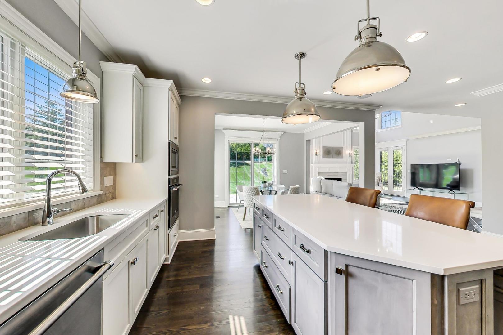8310 Waterview Drive Burr Ridge, IL 60527 - Photo 6 of 35 a large kitchen with kitchen island a large counter space a large window and stainless steel appliances