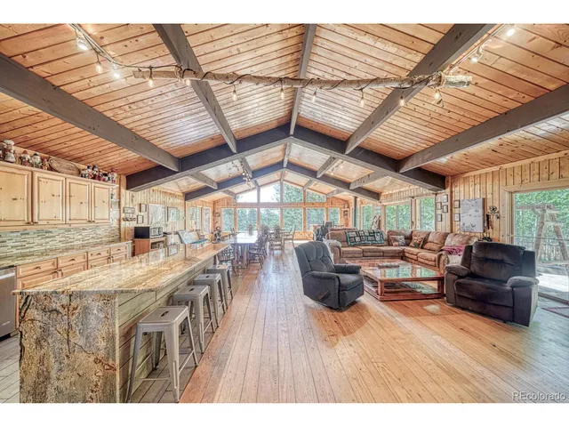 a living room with lots of furniture and a wooden floor