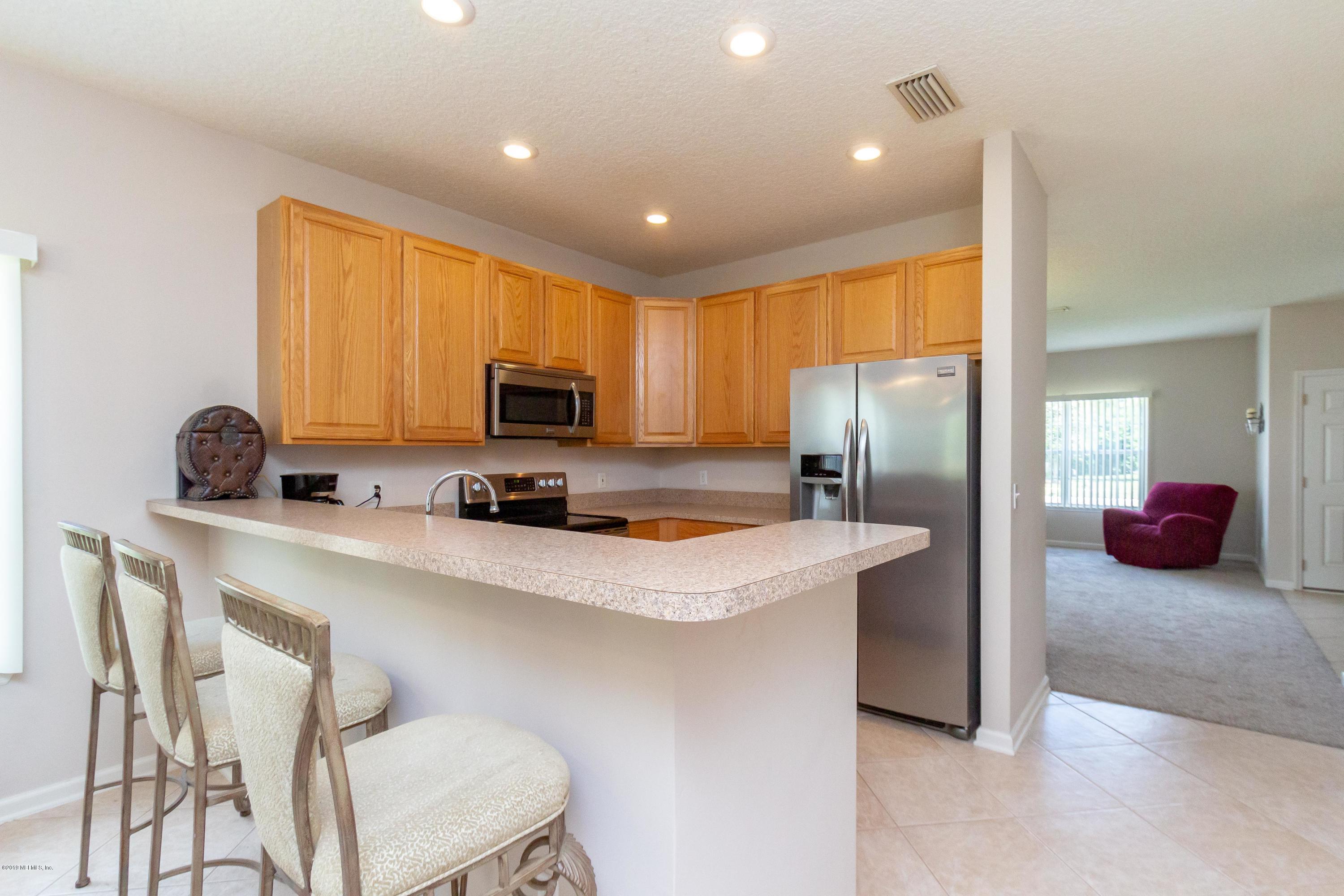 321 Stonehurst Parkway St. Augustine, FL 32092 - Photo 16 of 60 a kitchen with stainless steel appliances granite countertop a stove a sink a refrigerator and a refrigerator