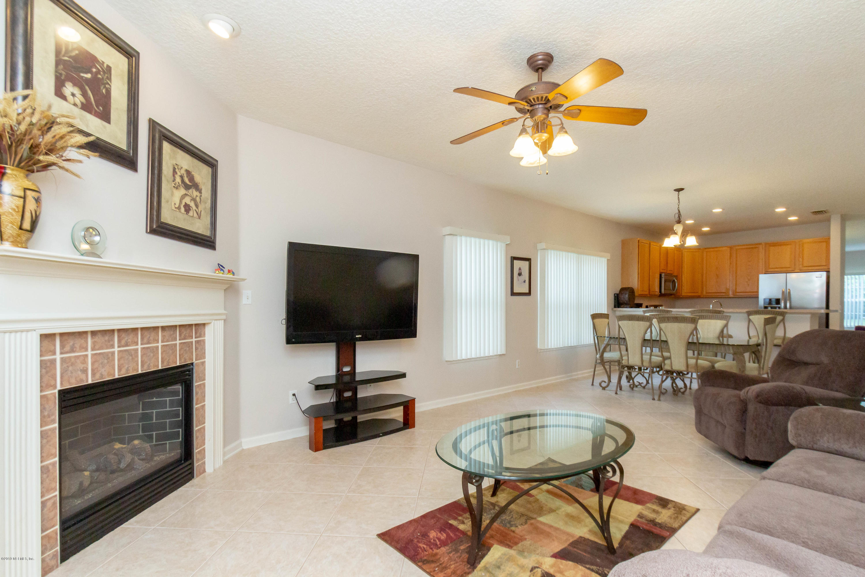 321 Stonehurst Parkway St. Augustine, FL 32092 - Photo 23 of 60 a living room with furniture a fireplace and a flat screen tv